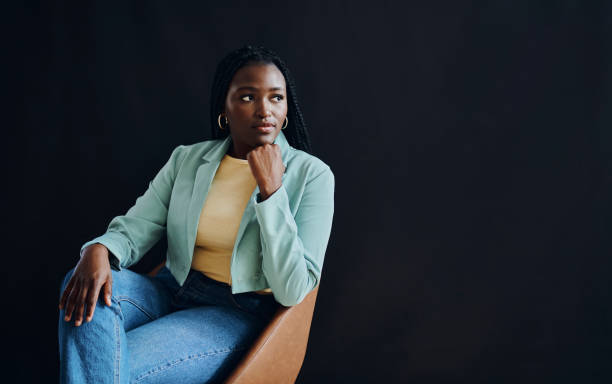 Idea, black woman and thinking for future, planning and female entrepreneur on black studio background. African American lady, girl and focus with fantasy, wonder and thoughts for career strategy