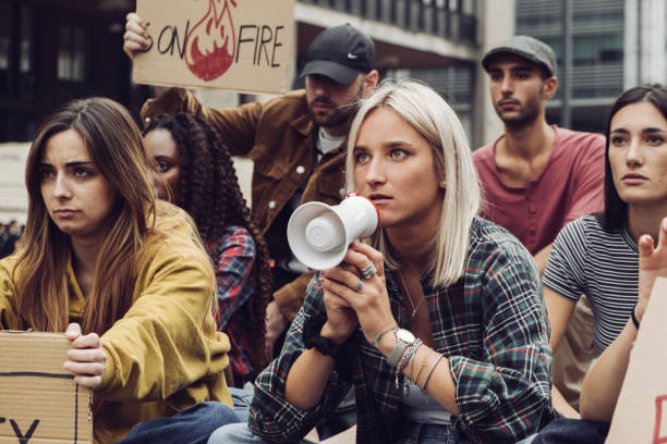 istock young protester sit-in - group of generation z people protesting against global warming 1460183654