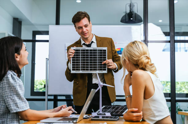 istock Business person meeting on solar cell panel technology. Business People Discussing Solar Power Environment Concept 1460185599