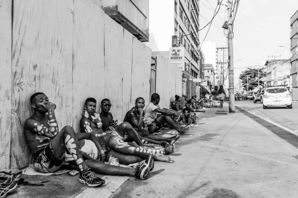 Luanda, Angola - May 17, 2024: People engage in lively conversations at a street market in Luanda Angola with vendors selling various goods and a vibrant community atmosphere prevalent.