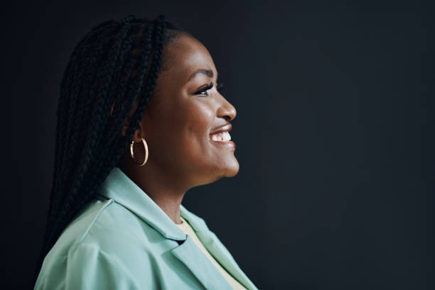 istock Corporate leader and black woman with thinking profile in studio with optimistic vision and goals mindset of people. Happy career person at isolated black background with mockup for advertising. 1460185806