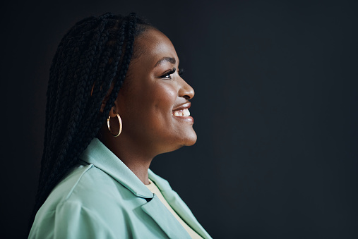 Corporate leader and black woman with thinking profile in studio with optimistic vision and goals mindset of people. Happy career person at isolated black background with mockup for advertising.
