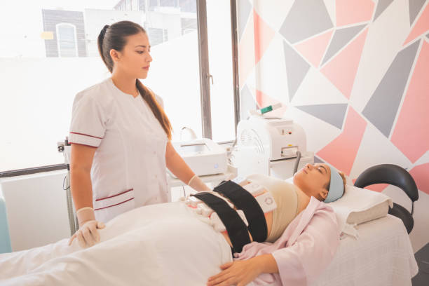 istock Female physical therapist doing electrostimulation therapy on a woman in the spa 1460186038