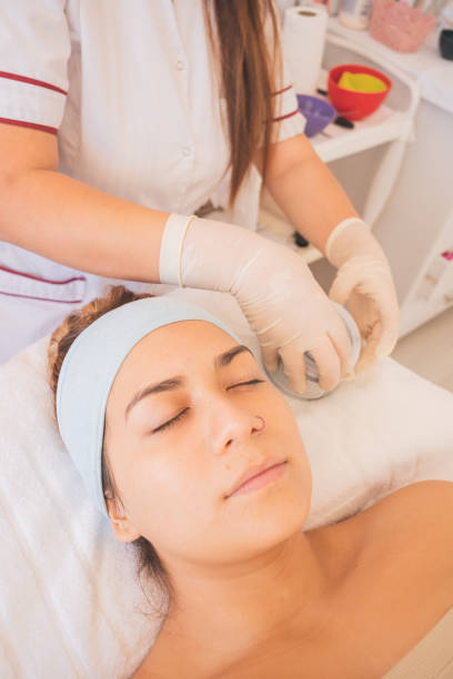 istock Young Hispanic female getting face care Spa treatment 1460187079