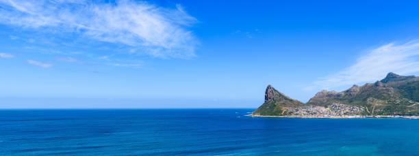 istock Panoramic shot Hout Bay with rugged coastal mountain and blue sea 1460187950