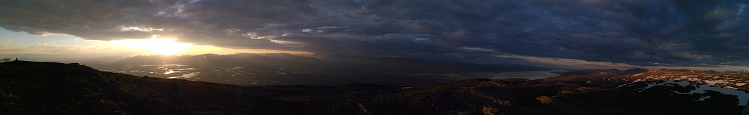 A panoramic view of a sunset over the hills