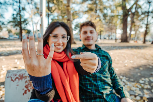 istock marriage proposal in a park, a young couple 1460188173