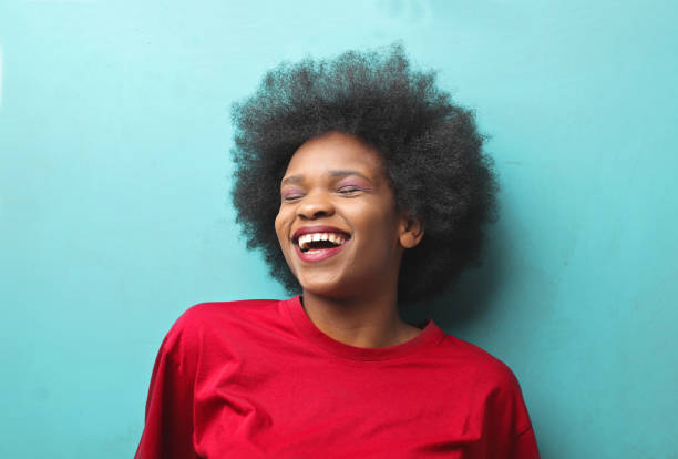 istock Young black woman laughing on a blue background 1460188728