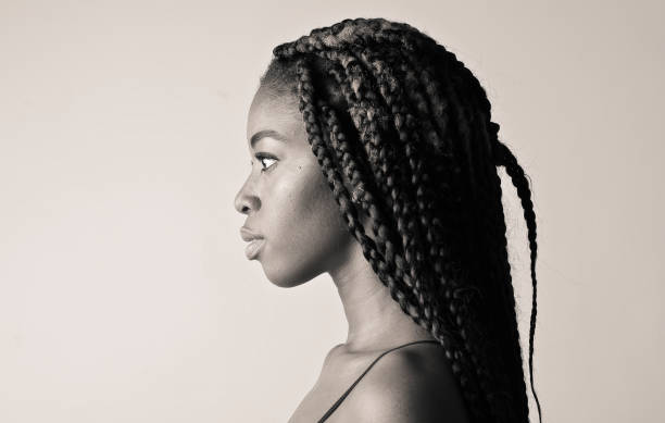 side profile of a young african american woman with long braided hair - braided braids women long hair imagens e fotografias de stock