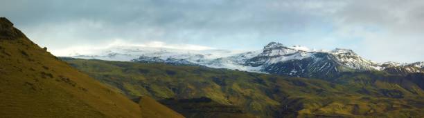 istock Beautiful panorama of snow covered mountain range 1460189501