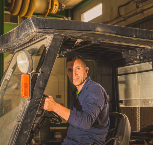 istock Young Latino male driving a forklift in an industrial workshop 1460190944