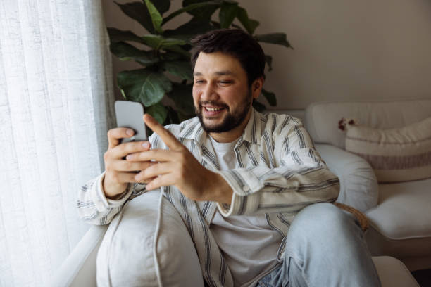istock Young Man looking at smart phone 1460191345