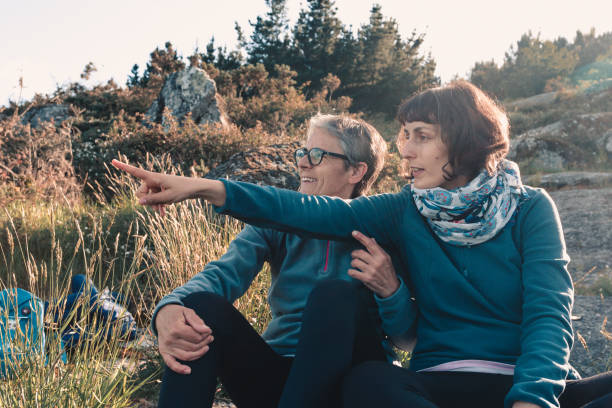 istock Daughter and mother looking at something in the forest 1460191507