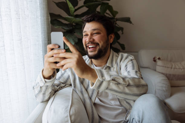 istock Young Man looking at smart phone 1460191784