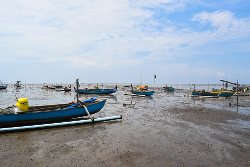 Fishing boat on the beach with blue sky background in Indonesia