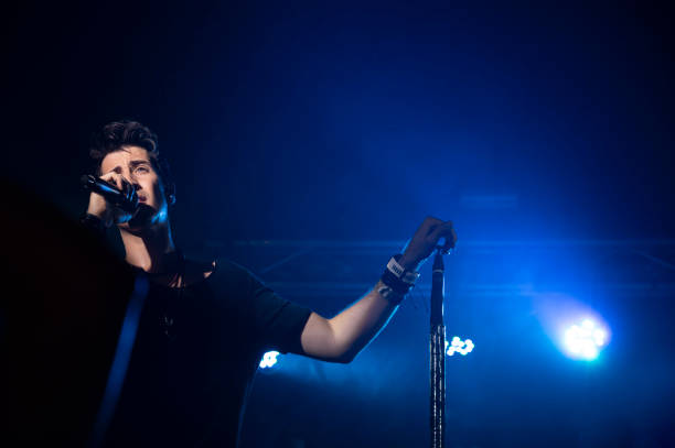 istock Young energetic singer performing during a concert in a club 1460194314