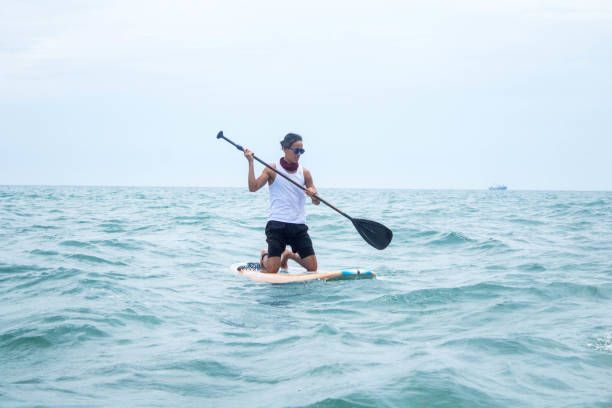 istock Skilled male Hispanic paddleboarder on his paddleboard at sea 1460194852