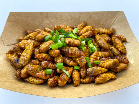 The fried insects are traditional snack in many Asian countires. Here is the fried silkworm pupa in China.