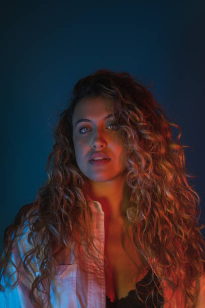 istock Sexy woman looking at the camera on a blue background 1460195732