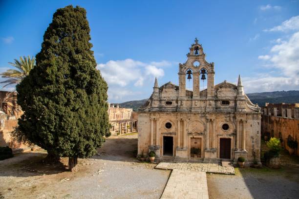 istock Old cathedral church with a tree on the side under a blue cloudy sky 1460196151