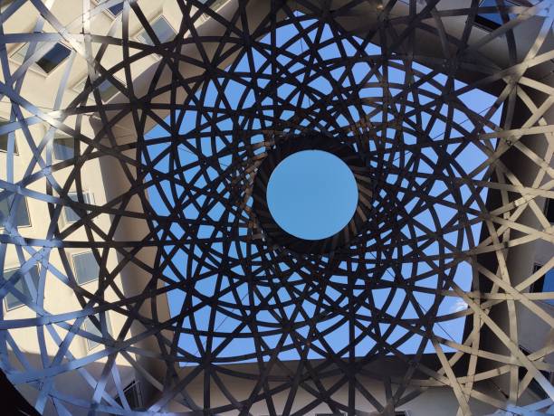istock Low angle of a metal abstract structure with blue sky seen through the holes 1460196381