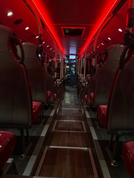 Interior of a bus illuminated with red light.