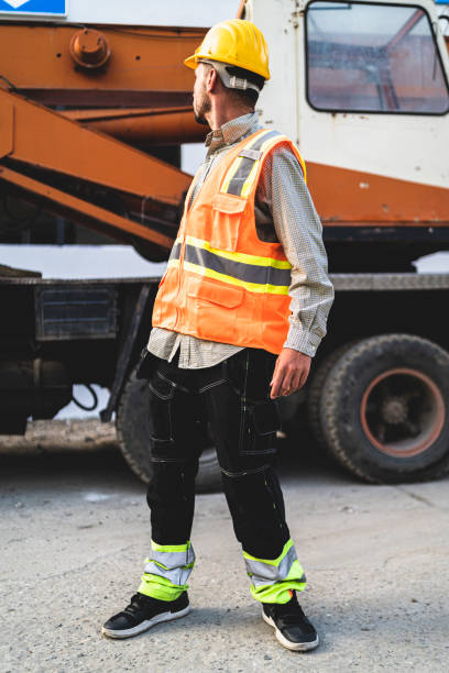 istock Vertical closeup of the worker looking back at the car. 1460198140