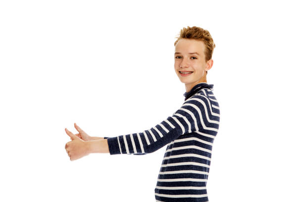 The standing young fashion model boy with the white background