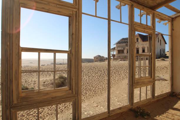 Abandoned building in sand on a sunny day, Ghost village Kolmanskop, Namibia An abandoned building in sand on a sunny day, Ghost village Kolmanskop, Namibia kolmanskop namibia stock pictures, royalty-free photos & images