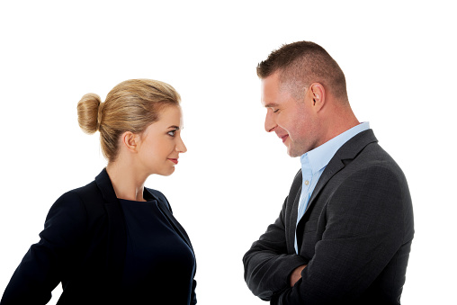 The Caucasian man and a woman talking to each other on white background