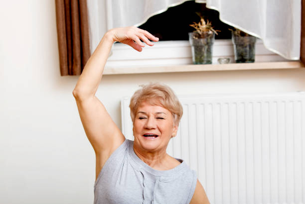istock Elderly Polish woman exercising inside the house 1460203077