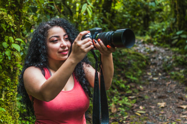 istock Smiling Hispanic female taking photos in a jungle 1460206529