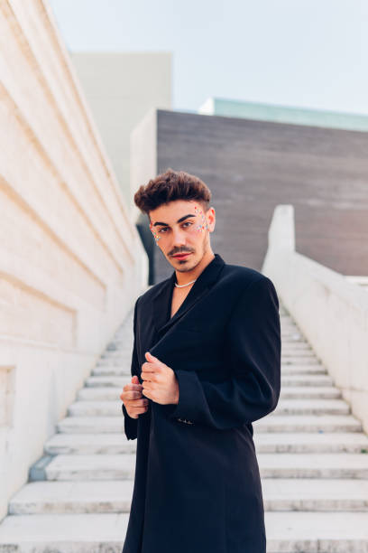 istock Confident stylish man in long coat on steps 1460206676