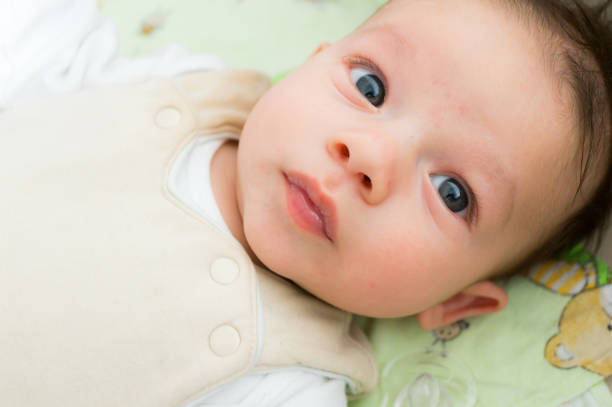 istock Cute Caucasian kid with big eyes lying on its bed 1460208369