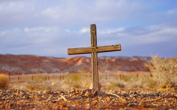 istock Image of a single wooden corss on the ground. 1460209775