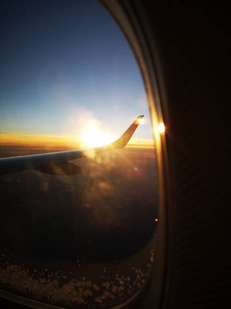 istock Vertical shot of the dawn before sunrise from a plane window 1460209900