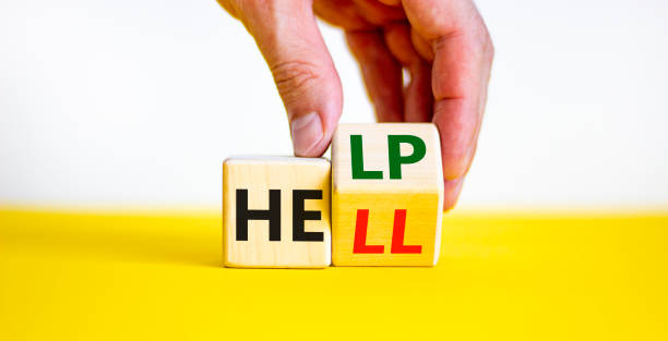 istock Hell or help symbol. Businessman turns a cube and changes the word 'hell' to 'help'. Business, psychology and hell or help concept. Beautiful white and yellow background, copy space. 1460212243