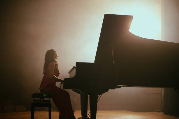 istock Woman playing the piano 1460217112
