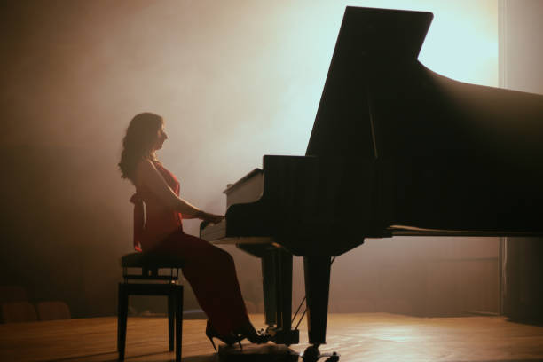 istock Woman playing the piano 1460217117