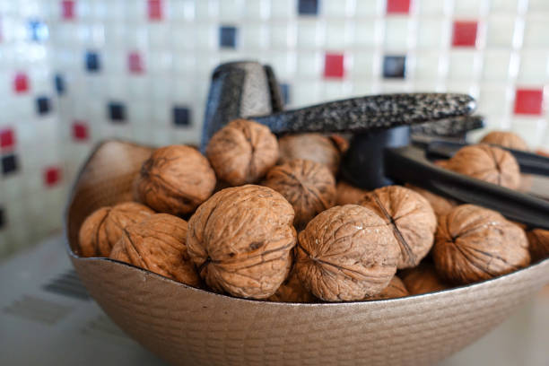 Shelled walnuts and walnut crushing apparatus in a large bowl,