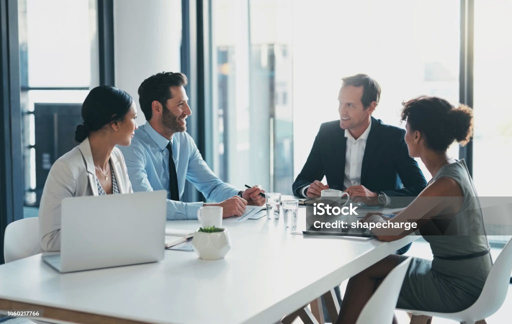 Business, teamwork and meeting in office with manager, collaboration and startup agency. Group, employees and corporate leadership at table for strategy, planning ideas and diversity of management Meeting Stock Photo