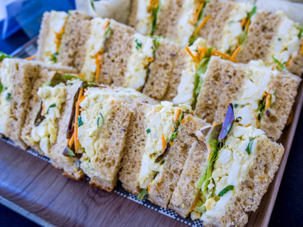 Egg and vegetable sandwiches sliced into bite sizes stock photo