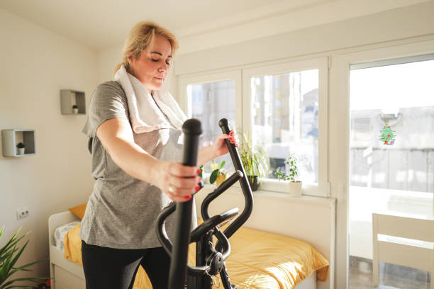 istock While exercises on an ski exercise machine woman looking at the calorimeter 1460221485