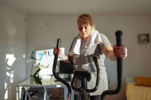 istock While exercises on an ski exercise machine woman looking at the calorimeter 1460221613
