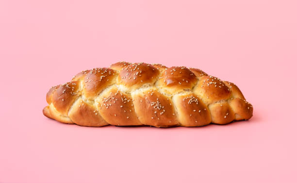 Braided bread isolated on a pink background. Homemade challah bread stock photo