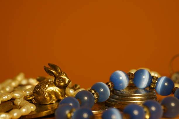Rabbit figurine with coins and jewelry.