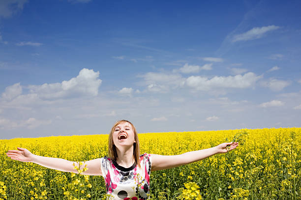 Happy girl on the rape field. stock photo