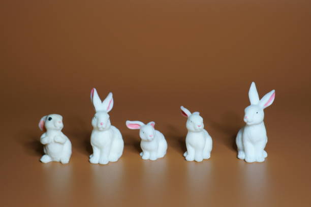 istock A group of toy rabbits on a brown background. 1460225796