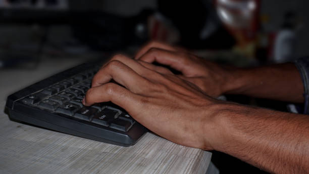 istock Close up of hands typing on computer keyboard lying on a wooden table. 1460229800