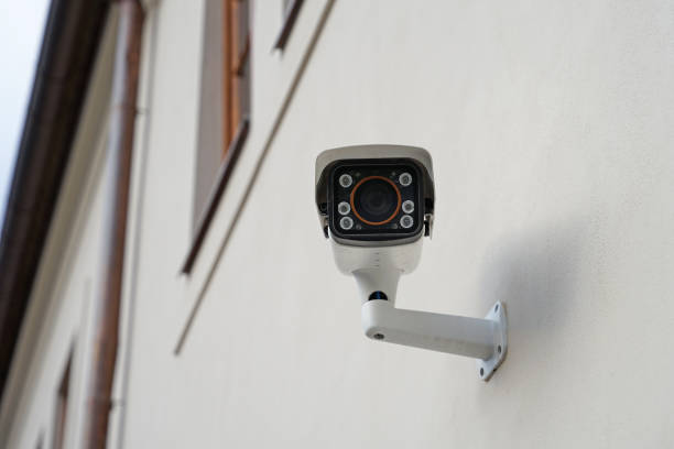 istock Modern smart outdoor cctv camera with night vision on house, protecting property against burglars and robbers 1460230721